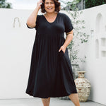 Model displaying women's plus size dress online - Ashleigh Dress in Black by Peach The Label