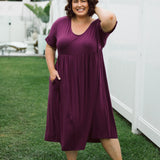 Model showcasing women's plus size dress online - Ashleigh Dress in Berry by Peach The Label