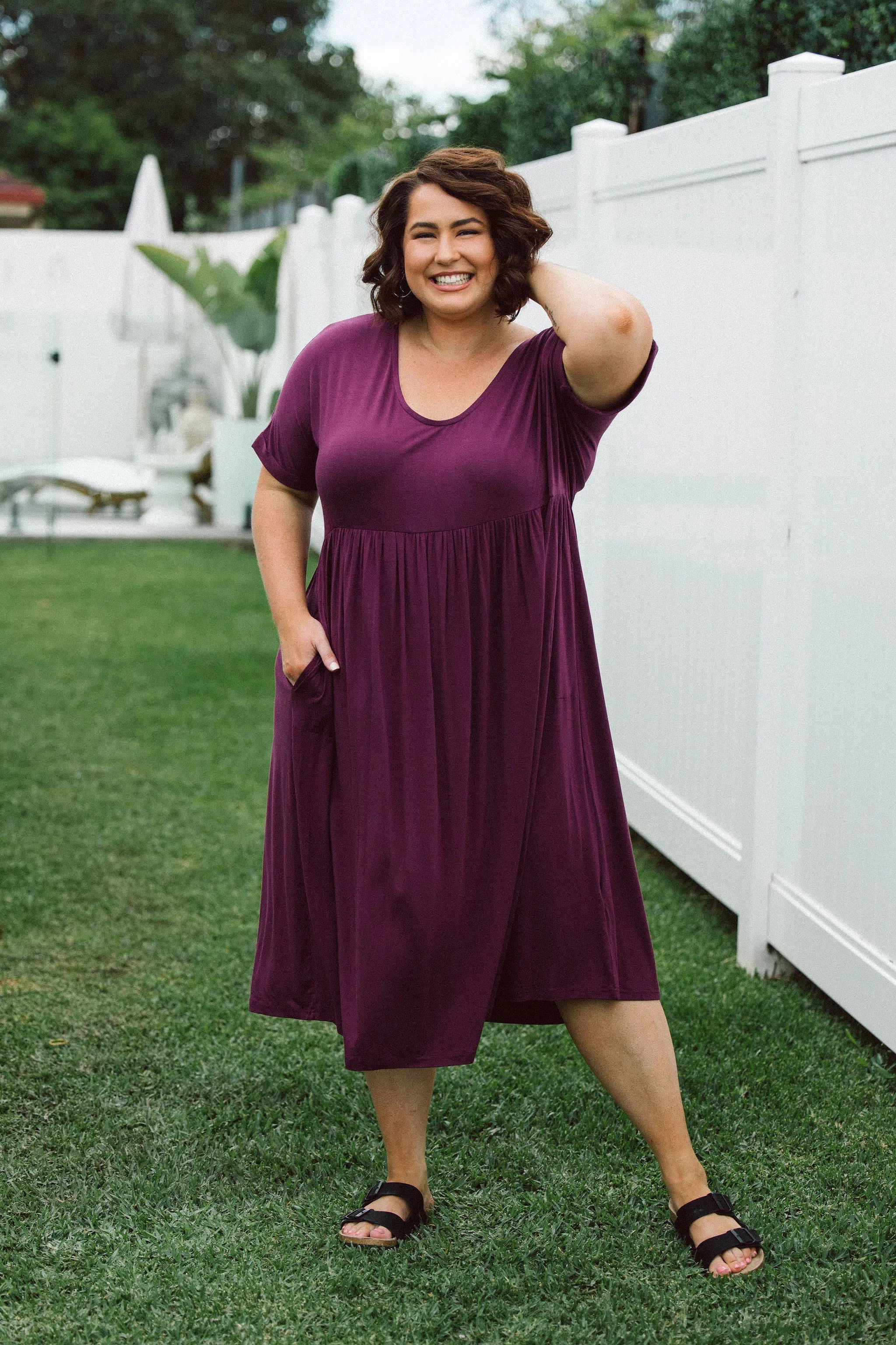 Model showcasing women's plus size dress online - Ashleigh Dress in Berry by Peach The Label